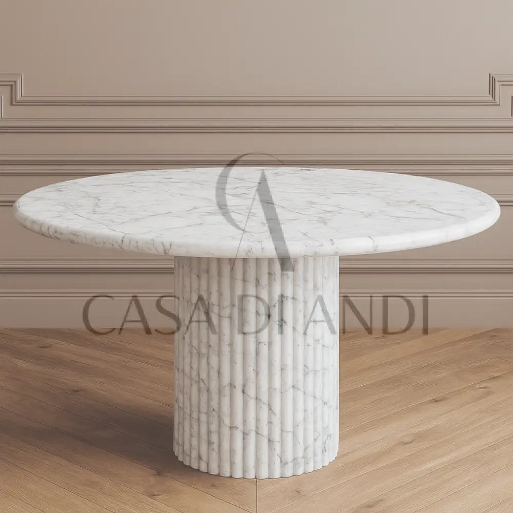 A luxurious round dining table made of Carrara white marble with fluted leg design made in Dubai.