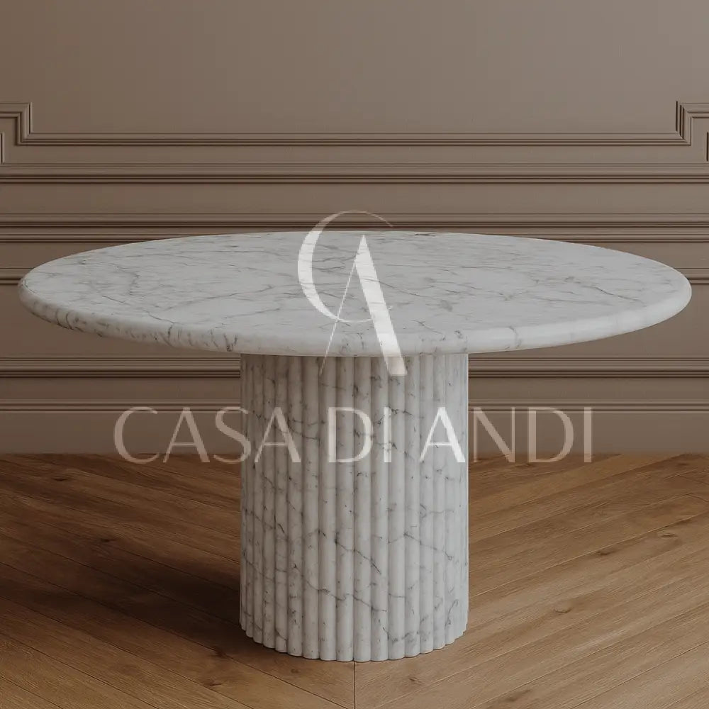 A luxurious round dining table made of Carrara white marble with fluted leg design made in Dubai.