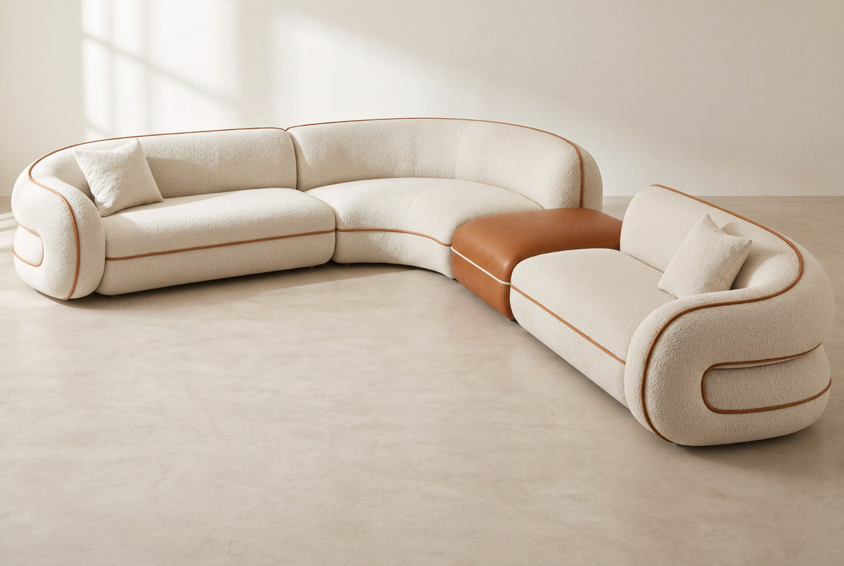 Anello modular corner sofa in ivory bouclé with cognac faux leather piping and ottoman