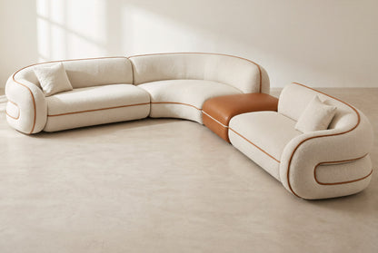 Anello modular corner sofa in ivory bouclé with cognac faux leather piping and ottoman