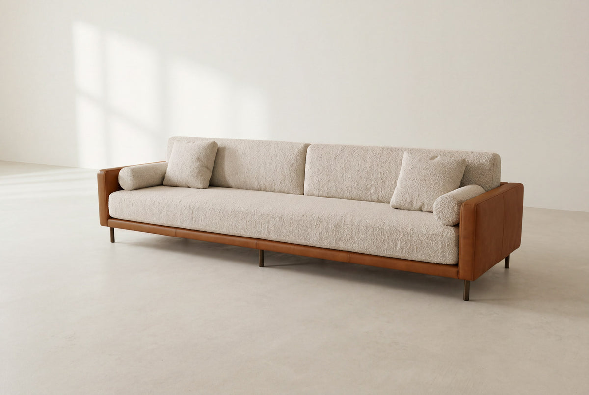 Sella framed sofa in cognac leather and ivory bouclé with round bolsters