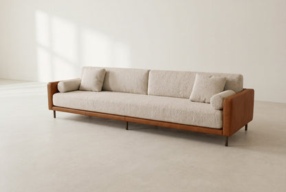 Sella framed sofa in cognac leather and ivory bouclé with round bolsters