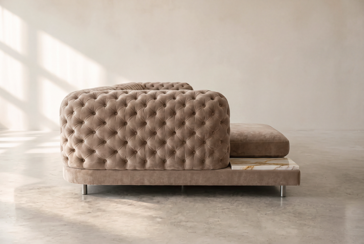 Palazzo chaise side view showing the tufted arm and marble side table
