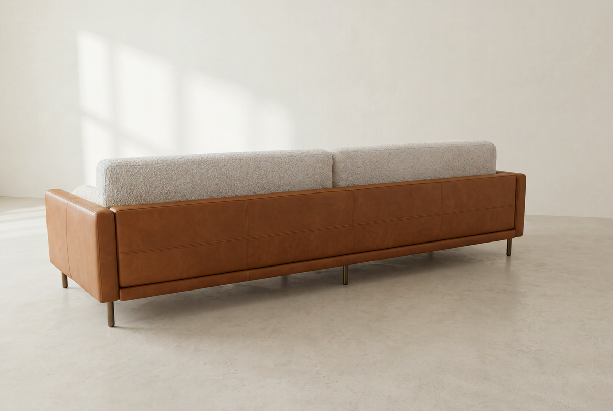 Sella sofa back view at an angle, cognac leather back