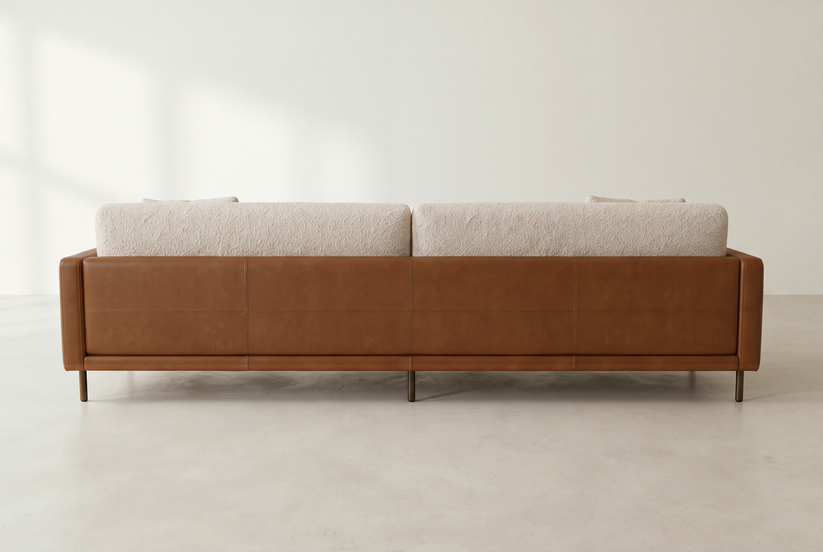 Sella sofa back view, continuous cognac leather frame