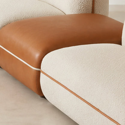Close-up of the cognac faux leather ottoman on the Anello sofa