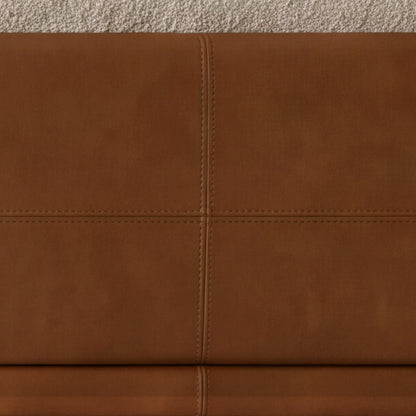 Close-up of the stitched cognac leather frame on the Sella sofa