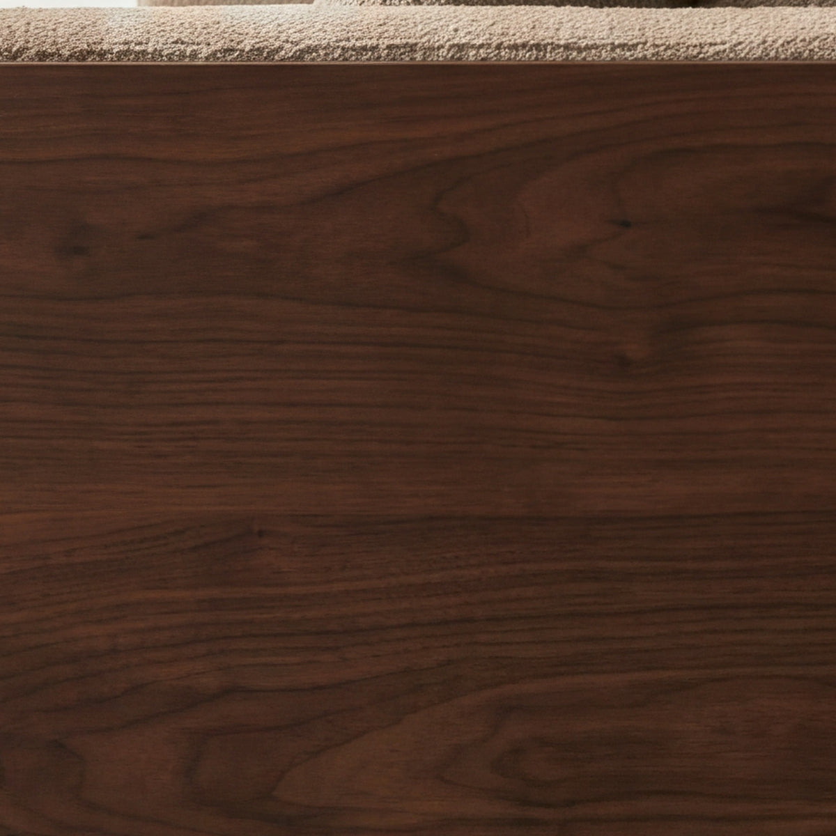 Close-up of the walnut-finish ash veneer on the Cornice sofa
