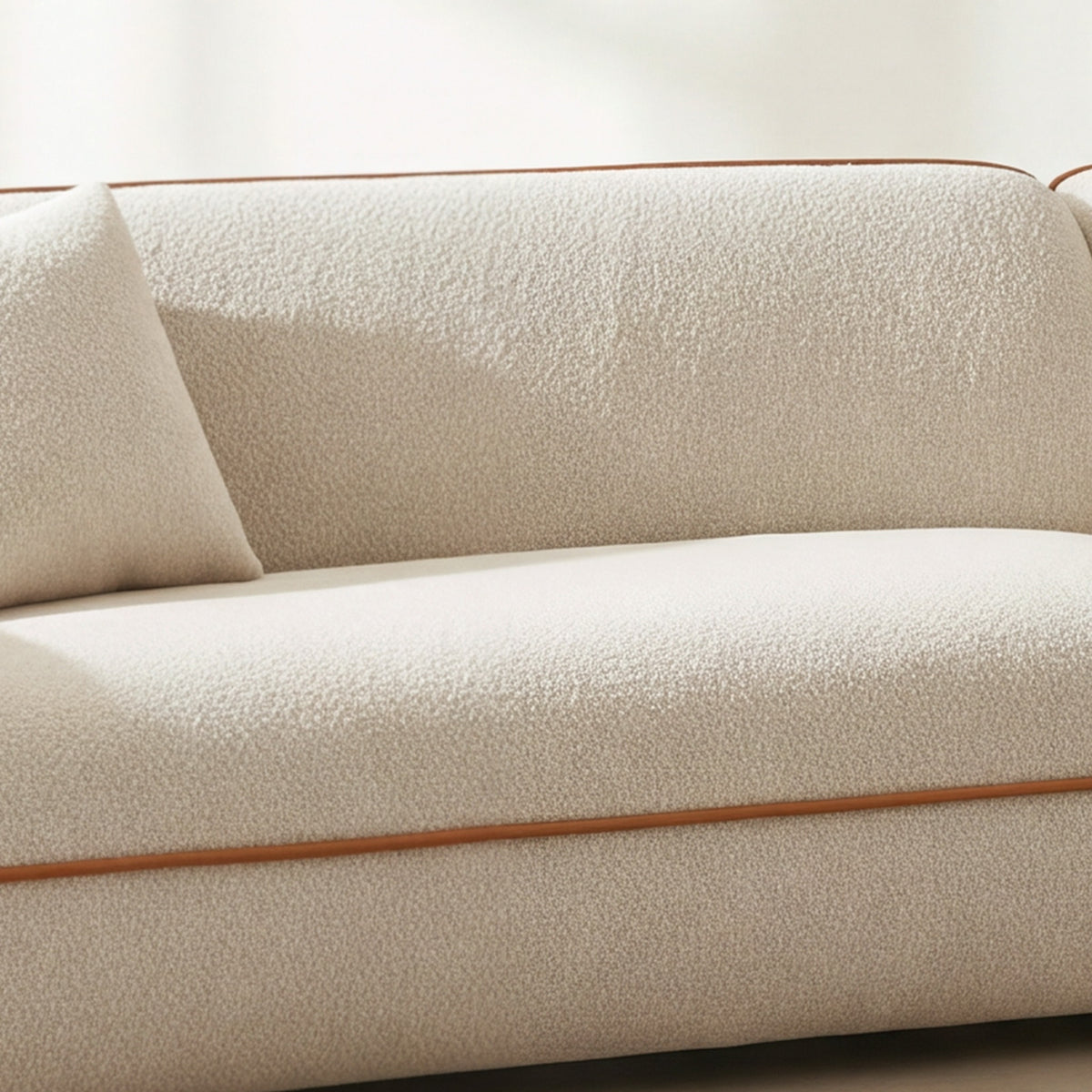 Close-up of the ivory bouclé seat on the Anello sofa 