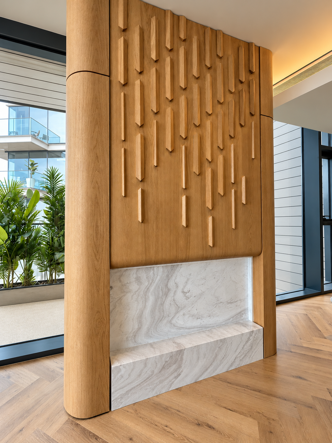 Custom oak relief feature wall with curved oak columns and a marble fireplace surround