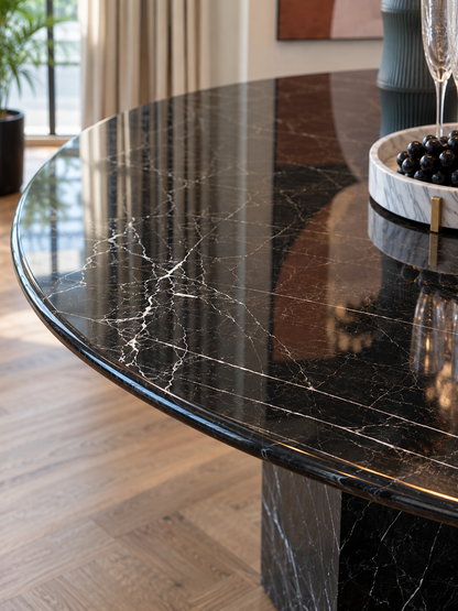 Close-up of polished Black Marquina marble round tabletop with natural white veining and rounded edge