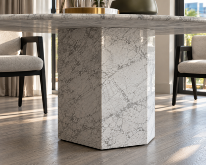 Close-up of the white Carrara marble block base of the Epico round dining table.