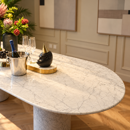 Close-up of the rounded end and grey veining on the Impero white Carrara marble oval table top