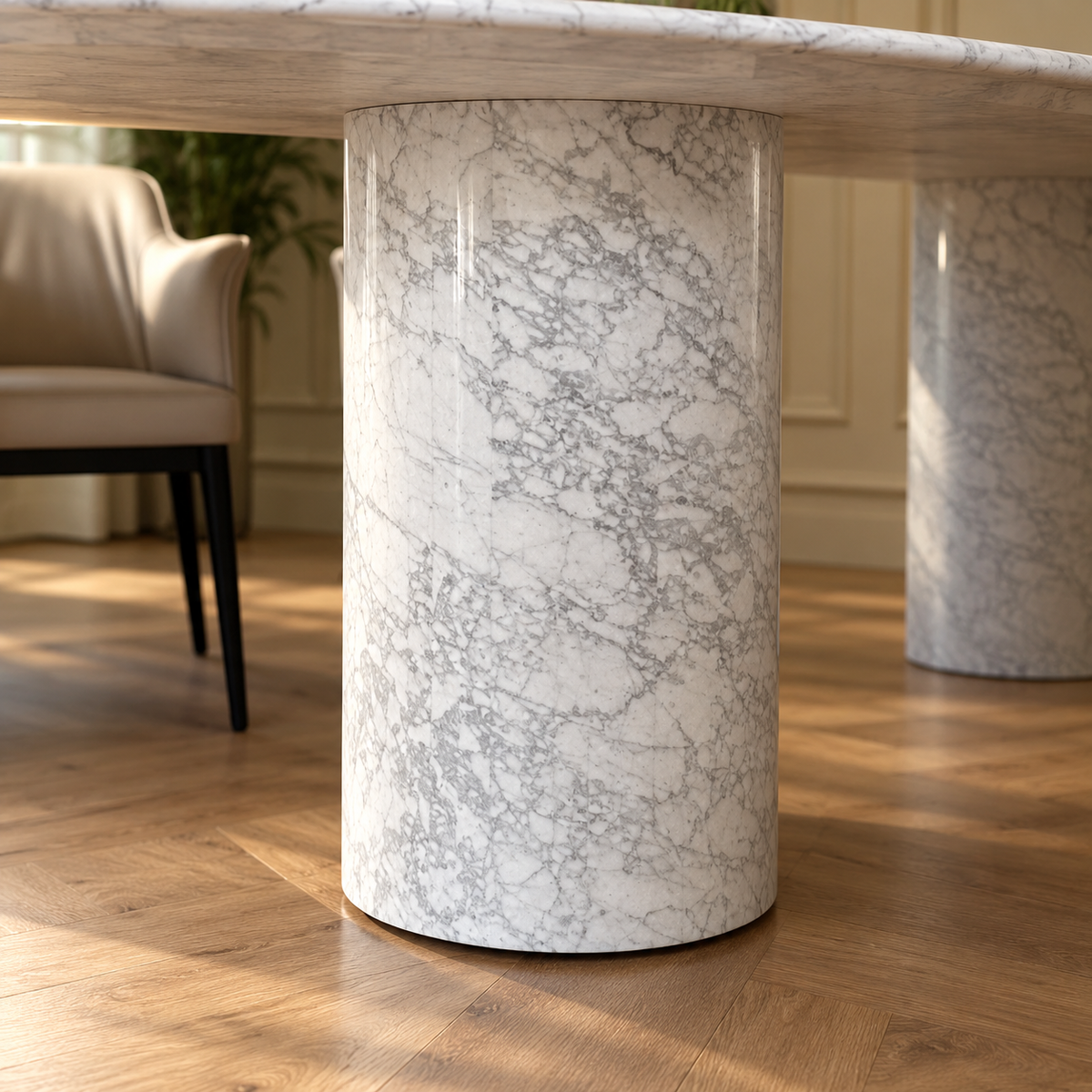 Close-up of a cylindrical white Carrara marble column base of the Impero oval dining table