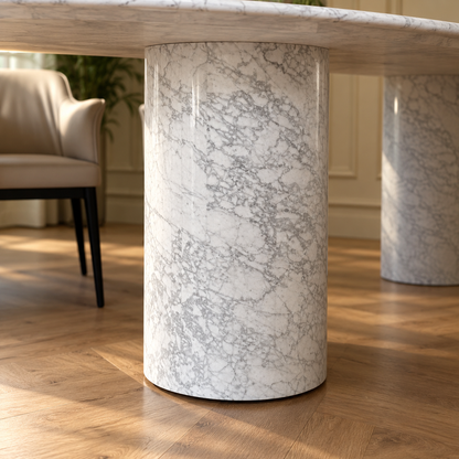 Close-up of a cylindrical white Carrara marble column base of the Impero oval dining table