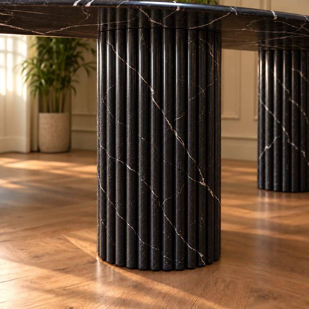 Close-up of the fluted Black Marquina marble column base of the Impero oval dining table