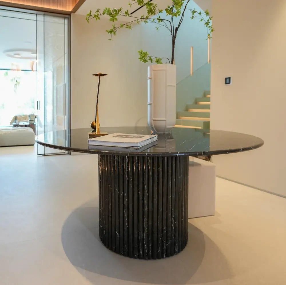 Dominio round dining table in Black Marquina marble with fluted base by Casa Di Andi Dubai