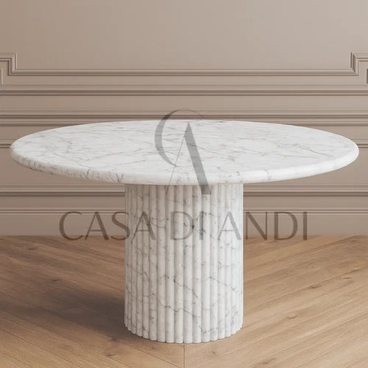 A luxurious round dining table made of Carrara white marble with fluted leg design made in Dubai.