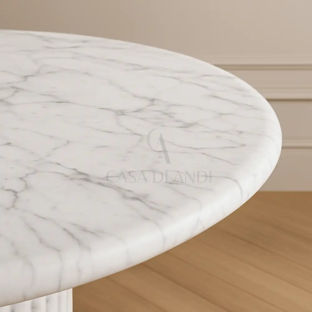 White Carrara marble round table with textured fluted base – Casa Di Andi Dubai