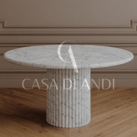 A luxurious round dining table made of Carrara white marble with fluted leg design made in Dubai.