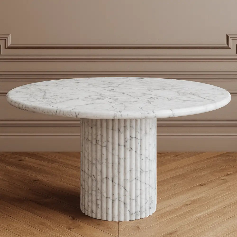 Round marble dining table with a fluted cylindrical base on a white background