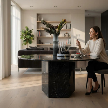 Woman sitting at a modern black marble dining table in a stylish living room Dubai